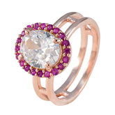 Josephine red halo ring for women featuring a large clear center stone surrounded by small red gemstones